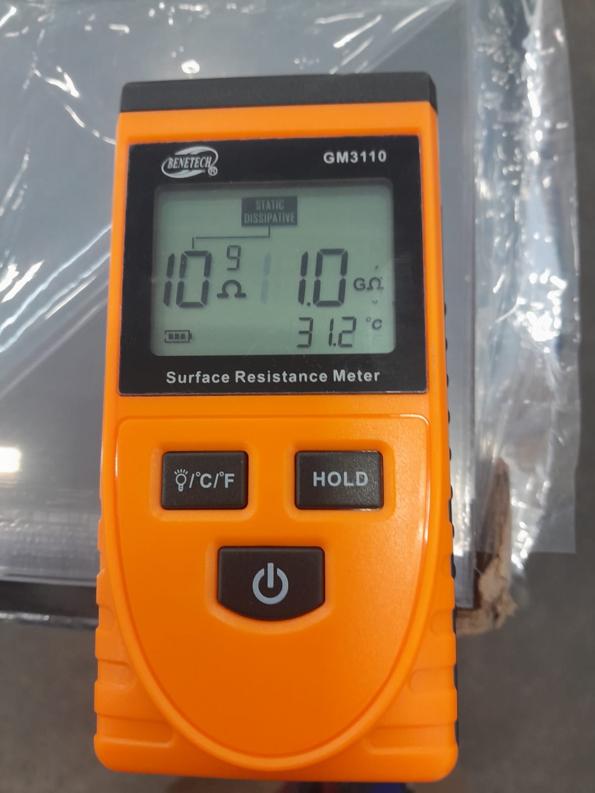 Surface resistance meter displaying 1.0 gigaohm on PC ESD material