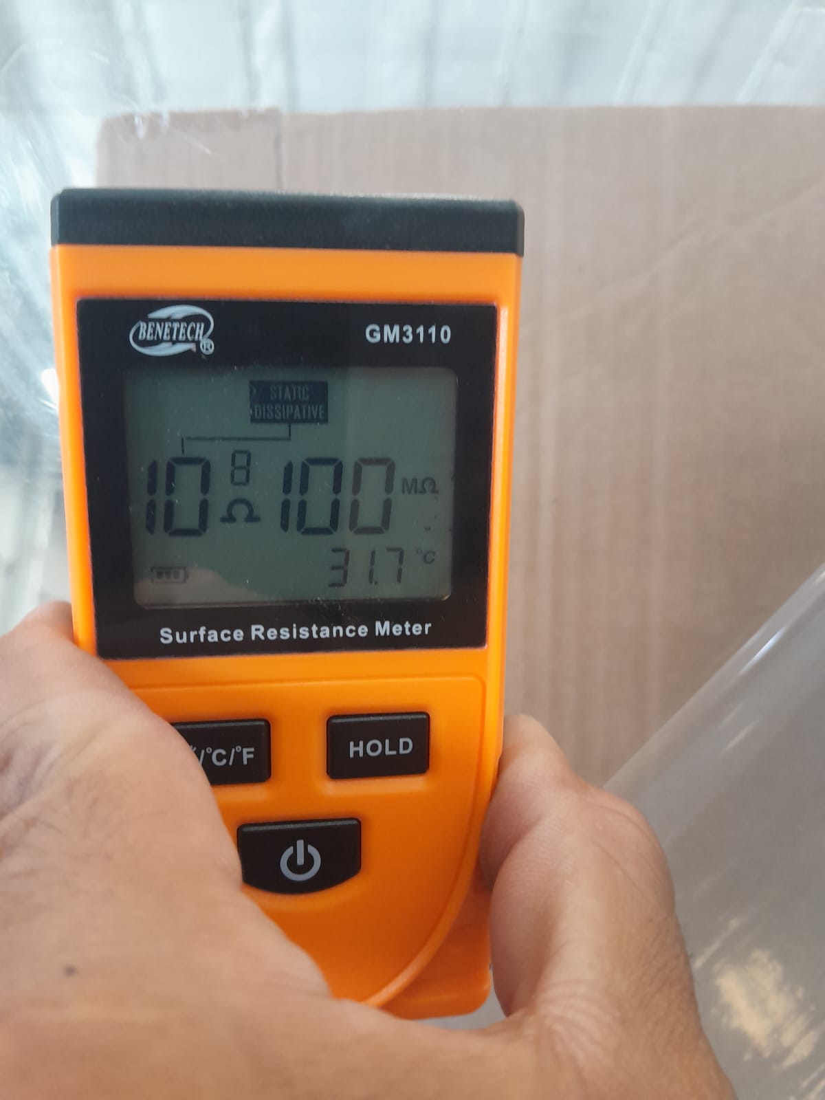 Surface resistance meter displaying 100 megaohms on PC ESD material